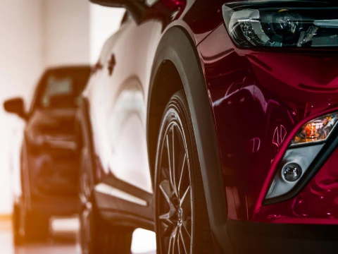 New luxury SUV compact car parked in modern showroom for sale. C