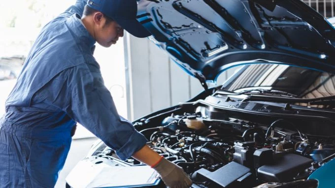Mecánico haciendo el mantenimiento del coche